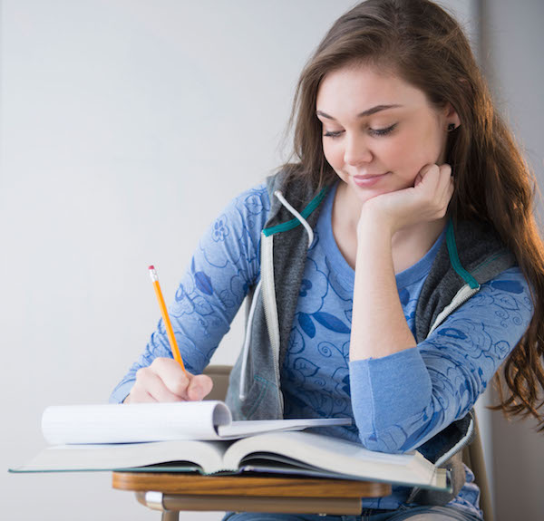 Hispanic girl studying at desk